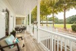 Beautiful front porch offers respite from the beach and views of beautiful croquet lawn.